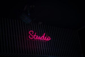 Neon studio sign illustrating browsing live cam categories, tags and filters